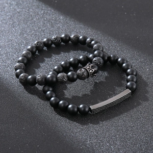 Matte black obsidian and volcanic stone beaded bracelet set with crown and metal bar