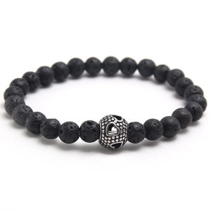 Natural black volcanic stone bead bracelet with hollow silver heart charm on white background