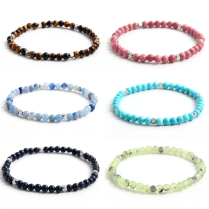 Set of 6 natural gemstone beaded bracelets with silver spacers on white background