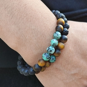 Men's natural lava rock and tiger eye beaded stretch bracelets on wrist display
