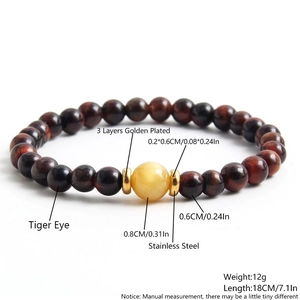 Red tiger eye stone beaded bracelet with gold spacers and 18cm elastic cord detail