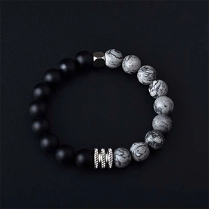Minimalist beaded bracelet with matte black and white marble beads and silver accents