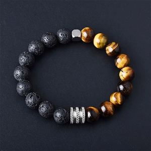 Macro shot of natural black volcanic rock and yellow tiger eye stone beads with metal spacers