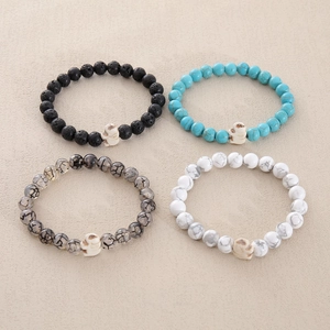 Detailed view of 8mm natural stone beaded bracelets with white skull charms and lava rock
