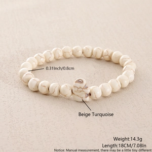 Detail of 8mm beige turquoise beaded bracelet with natural texture and cross charm