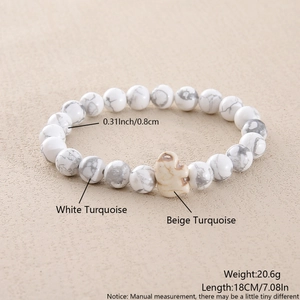Detail of 8mm white turquoise beaded bracelet with a beige elephant stone charm