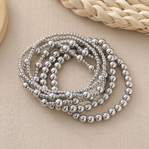 Polished silver beaded bracelet set with 3mm to 6mm copper beads for layered styling