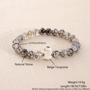 Detail view of 8mm natural dragon vein agate beads with beige turquoise elephant charm