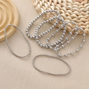 Set of silver beaded stretch bracelets with polished metallic spheres in a boho style