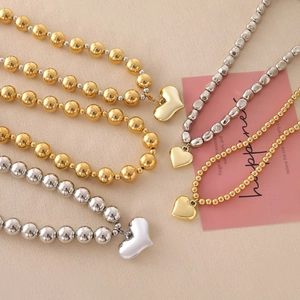 Exaggerated metal beaded necklace with heart pendants in gold and silver plating
