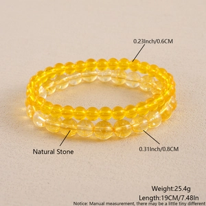 Detail of 6mm and 8mm yellow natural stone beaded bracelets with glossy finish