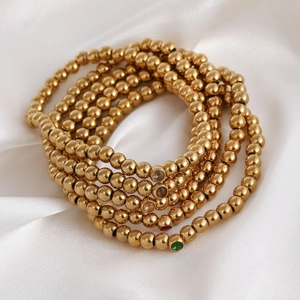 Stackable 18K gold plated stainless steel bead bracelets with colorful gemstone accents