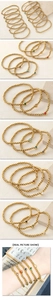 Detail of gold beaded bracelets featuring colorful heart zircon charms on elastic bands