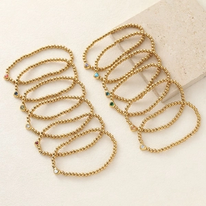 Golden beaded bracelet set with colorful heart-shaped cubic zirconia charms for women