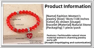 Detail of red bead bracelet with stainless steel heart pendant and pulse pattern