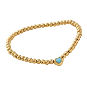 Gold beaded stretch bracelet with a heart-shaped turquoise stone pendant for women