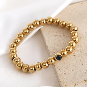 18K gold plated stainless steel elastic bracelet with blue gemstone bead and shiny finish