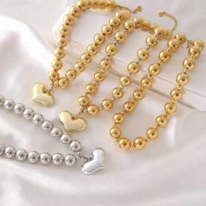 Luxury metallic beaded necklace set with polished heart pendant in gold and silver