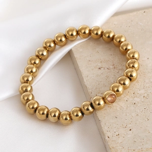 Polished 18K gold plated beaded stretch bracelet featuring a single sparkling zircon bead