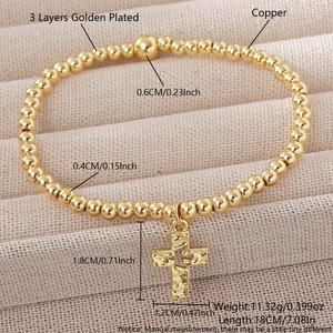 Golden copper beaded stretch bracelet with hammer-textured cross pendant and 18k plating
