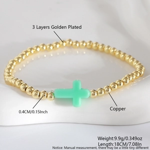 Beaded bracelet with 4mm golden copper beads and mint green cross charm detail