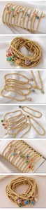 Detail showing multi-colored natural stones on beaded gold bracelets set on silk