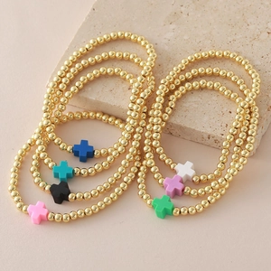 Set de 7 pulseras elásticas de cruces de colores con cuentas doradas en piedra