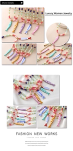 Detail showing colorful enamel fish charms and golden beads on handmade necklaces