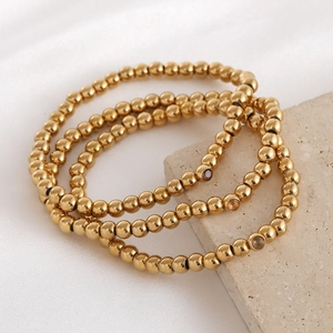 Lot de trois bracelets en perles dorées d'acier inoxydable avec zircons colorés ronds