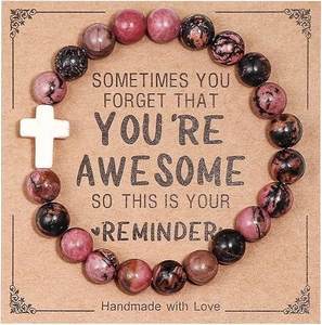 Pink zebra jasper beaded bracelet with white turquoise cross on kraft paper display card