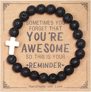 Detail of beaded volcanic stone bracelet with cross on a handmade kraft gift card