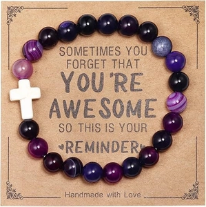 Handmade beaded bracelet with purple zebra jasper, black stones, and a white cross charm
