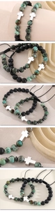 Detail view of African turquoise stone beads and silver cross charms with adjustable cord