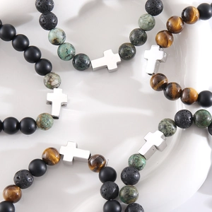 Cross beaded bracelet featuring natural tiger eye, lava rock and matte black onyx beads