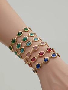 Close-up of vibrant faceted glass stone bracelets with 18k gold plating on model wrist