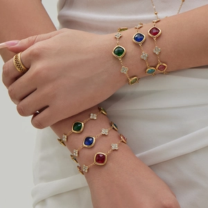 Elegant gold bracelet set with colorful square gemstones and clover charms for women