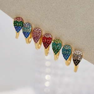 Set of 7 gold-plated rings featuring colorful teardrop-shaped cubic zirconia crystals