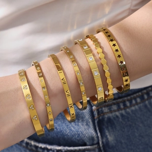Set of seven gold plated stainless steel bangles with Roman numerals and zircons