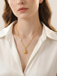 Detail of 18k gold plated bar necklace with GOLD engraving on an asymmetric chain