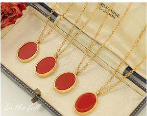 Detailed shot of vintage gold necklace with oval ruby pendant in a classic jewelry box