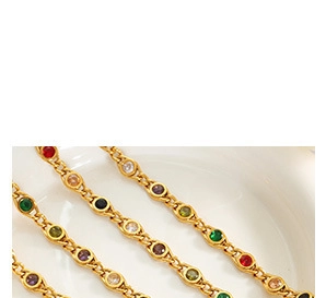 Close-up of gold chain necklaces with multicolored round gemstones in bezel settings