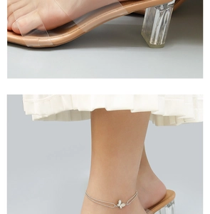 Close-up of double-layer butterfly anklet in silver finish with white wings detail