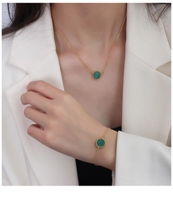 Detail of 18K gold plated necklace and bracelet set with green malachite pendant