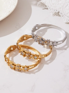 Bracelets étoiles en or et argent avec zircons 5A posés sur surface marbre