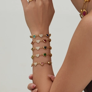 Golden bracelet set featuring colorful heart gemstones and sparkling zircon accents for women