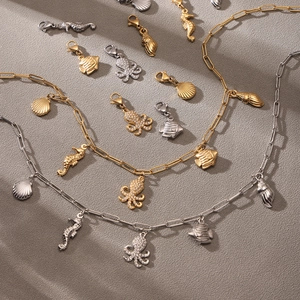 Nautical charm necklace set with starfish and octopus pendants on paperclip chain