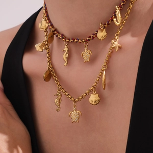 Ocean series gold layered necklace with seahorse, turtle, and starfish charms