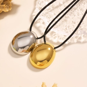Polished gold and silver drop pendants on adjustable black cords for minimalist styling