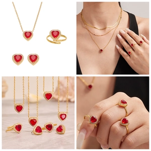 Detail of red heart zircon jewelry set including necklace, ring and earrings in gold plating