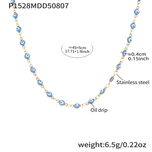 Gold stainless steel necklace with blue evil eye charms and oil drip finish